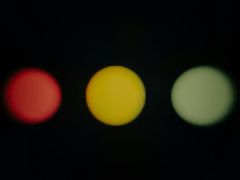 Three blurred colored circles on black background
